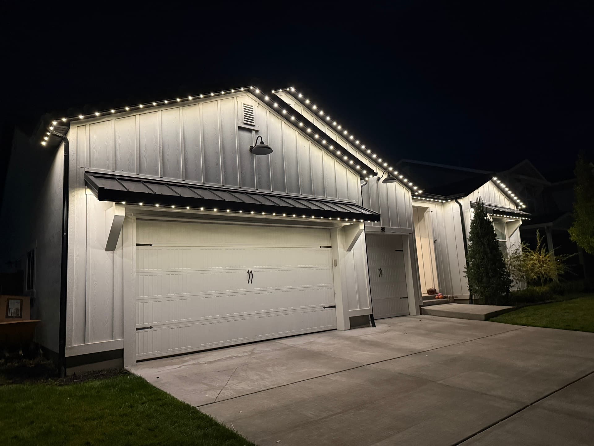 Farmhouse-style home showcasing permanent LED lighting color options